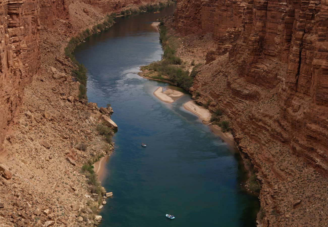 Steel arch suspension bridges spanning high across the deep red rock chasm of Marble Canyon and the Colorado River