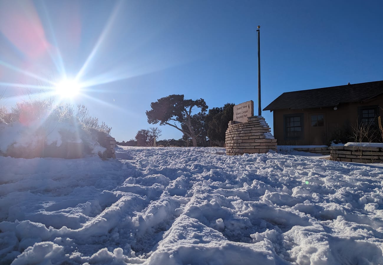 Historic Mary Colter stone watchtower perched directly on the cliff edge of the Grand Canyon South Rim