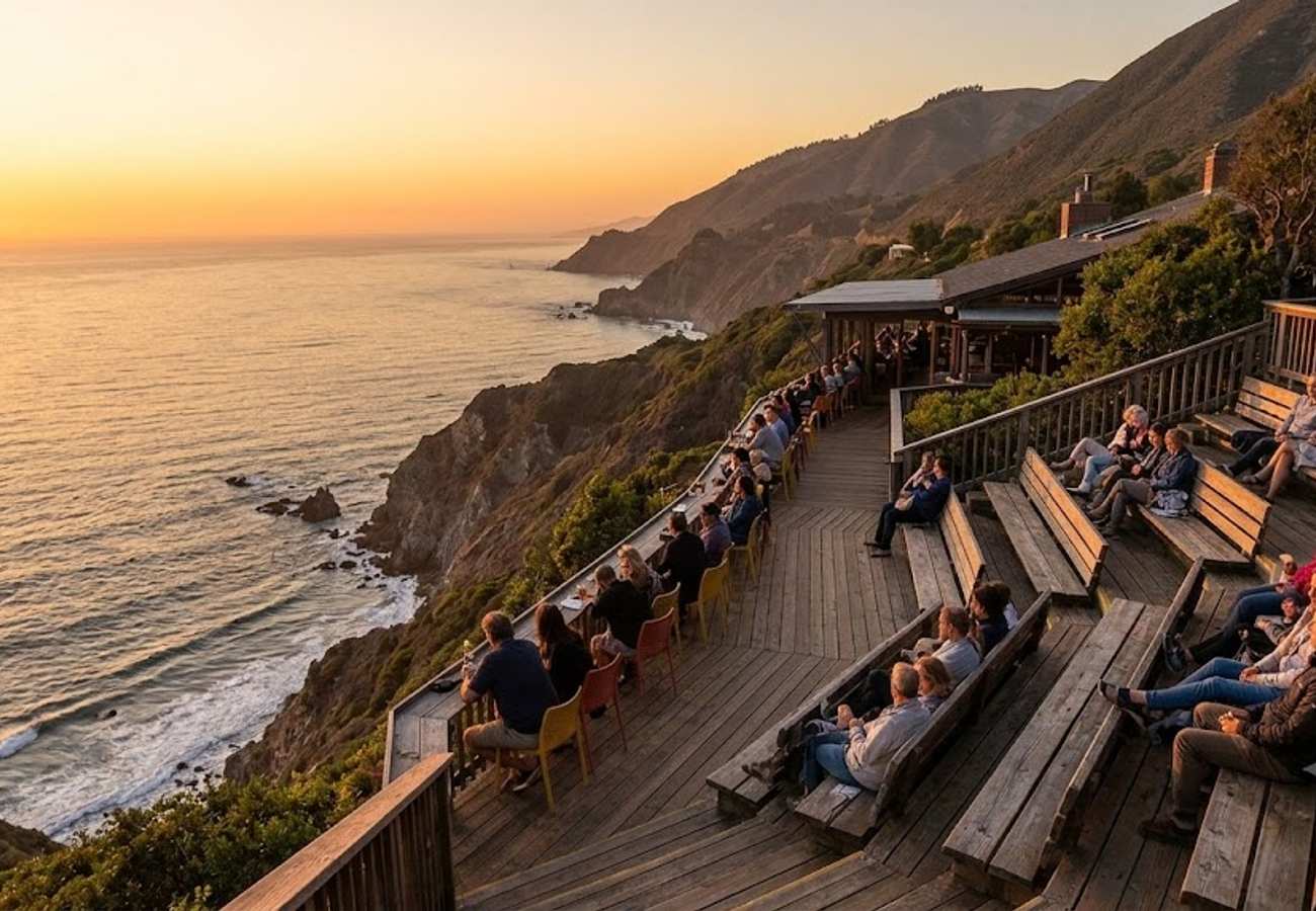 Outdoor wooden restaurant terrace perched 800 feet above the Pacific Ocean overlooking the misty coastline of Big Sur California