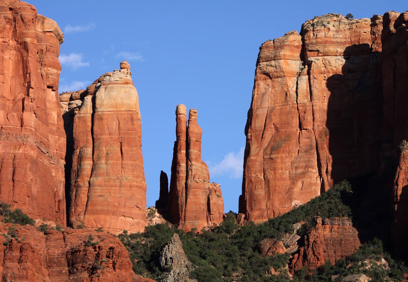 Cathedral Rock towering red sandstone formations glowing beneath blue skies in Sedona Arizona