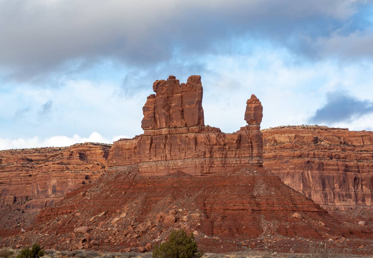 Solitary sandstone buttes and vast desert plains across the Valley of the Gods in southeastern Utah