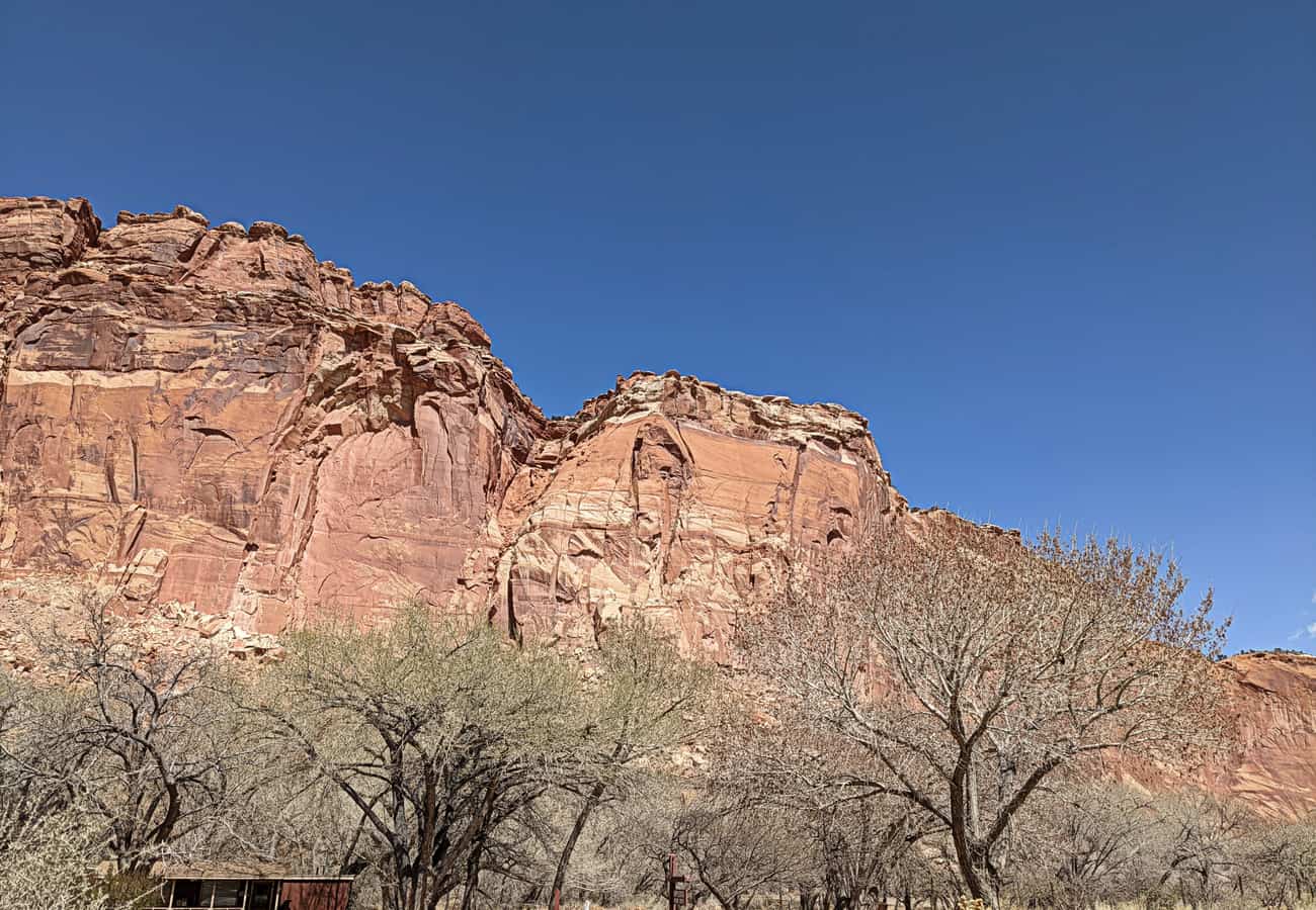 Paved two-lane Scenic Drive winding beneath massive sandstone domes in Capitol Reef National Park