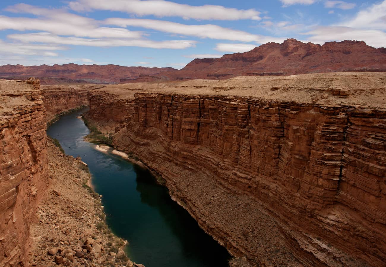 Historic Navajo Bridge arching high over the turquoise waters of the Colorado River in Marble Canyon
