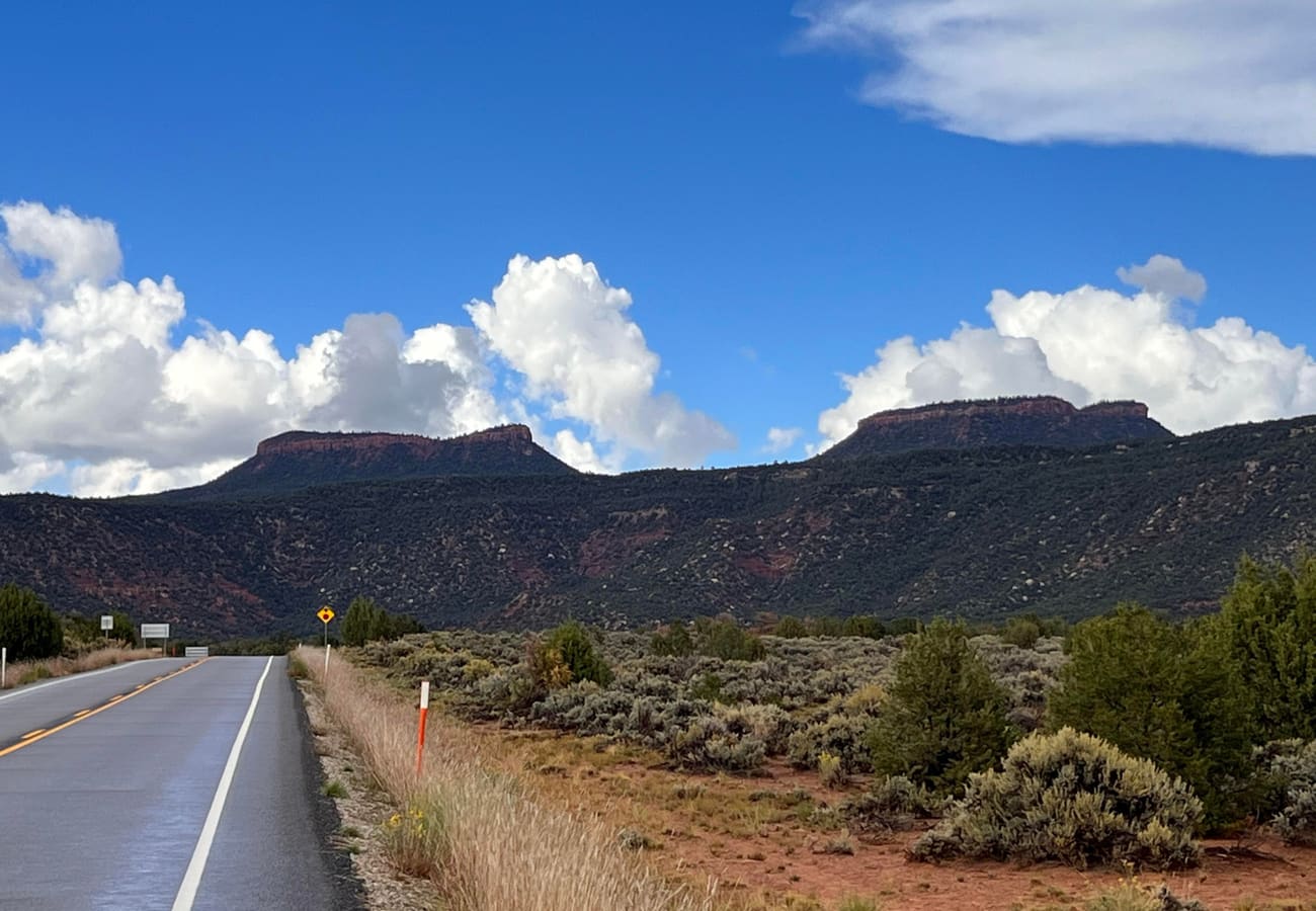 The prominent twin sandstone summits of Bears Ears Buttes rising over southeastern Utah wilderness