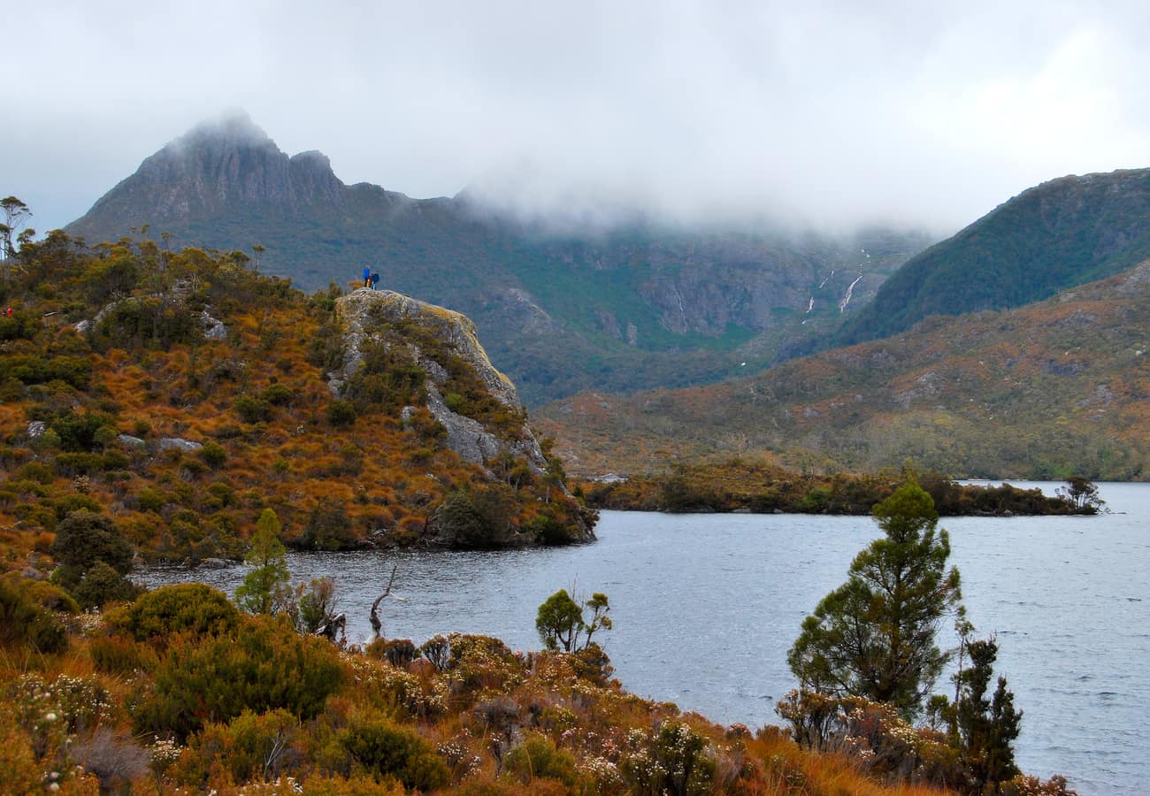 Misty Cradle Mountain reflected in the calm alpine waters of Dove Lake