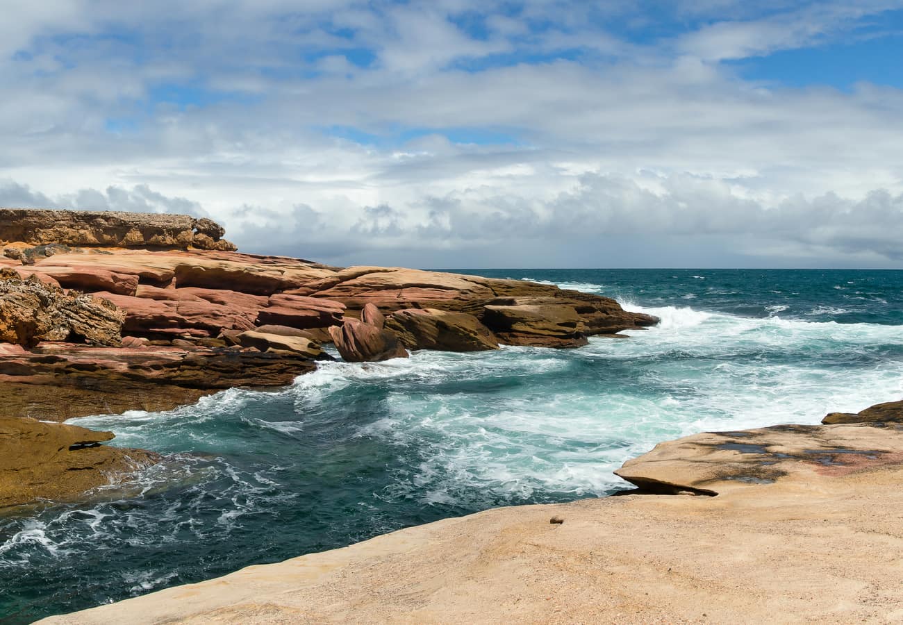 Emerald tropical rainforest meeting turquoise Coral Sea coastline in Queensland