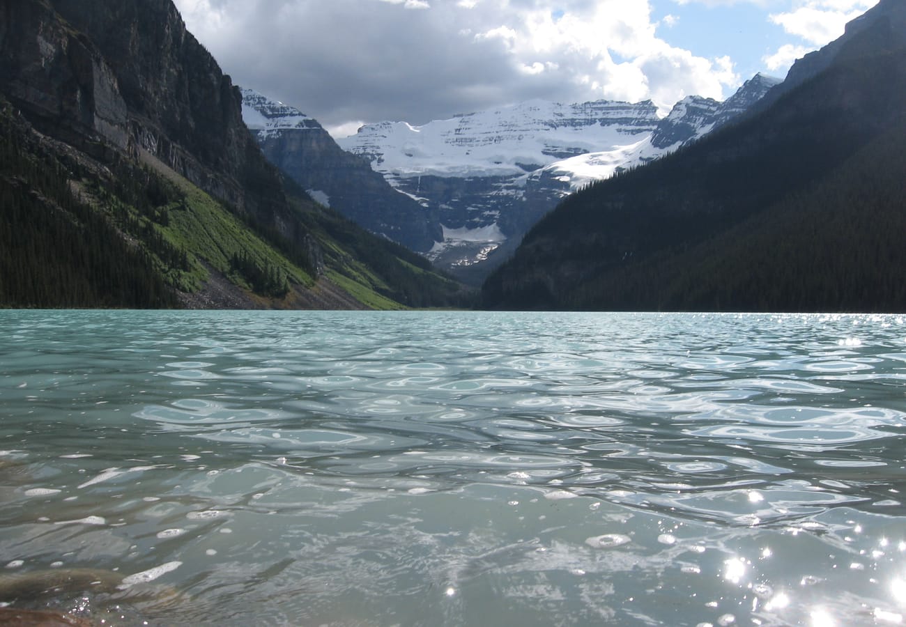 The glowing turquoise glacial waters of Lake Louise reflecting Mount Victoria and its hanging glacier