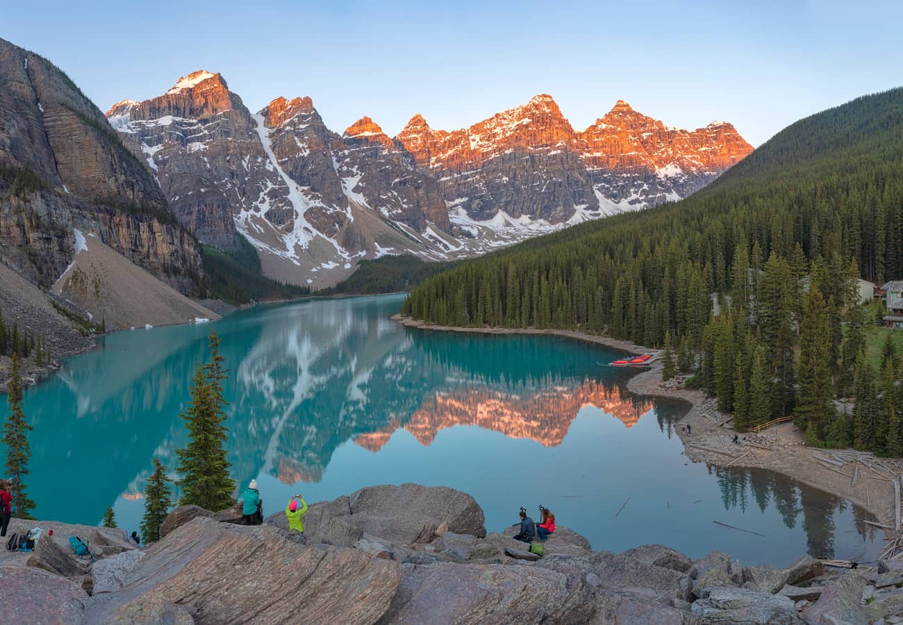 Panoramic view of Moraine Lake brilliant cobalt waters sheltered beneath the Valley of the Ten Peaks