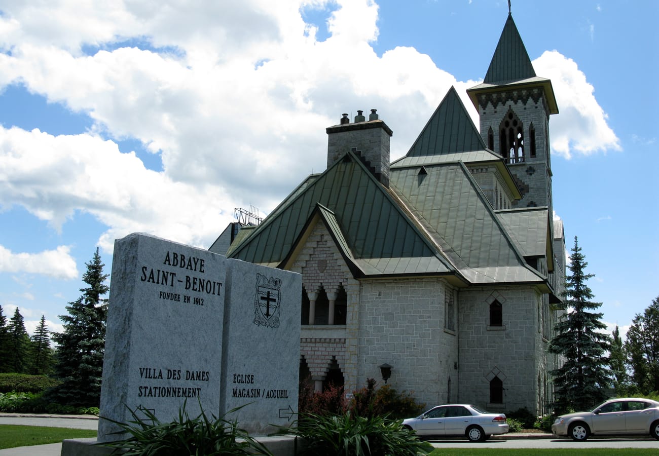 The historic stone towers of Abbaye de Saint-Benoit-du-Lac overlooking Lake Memphremagog