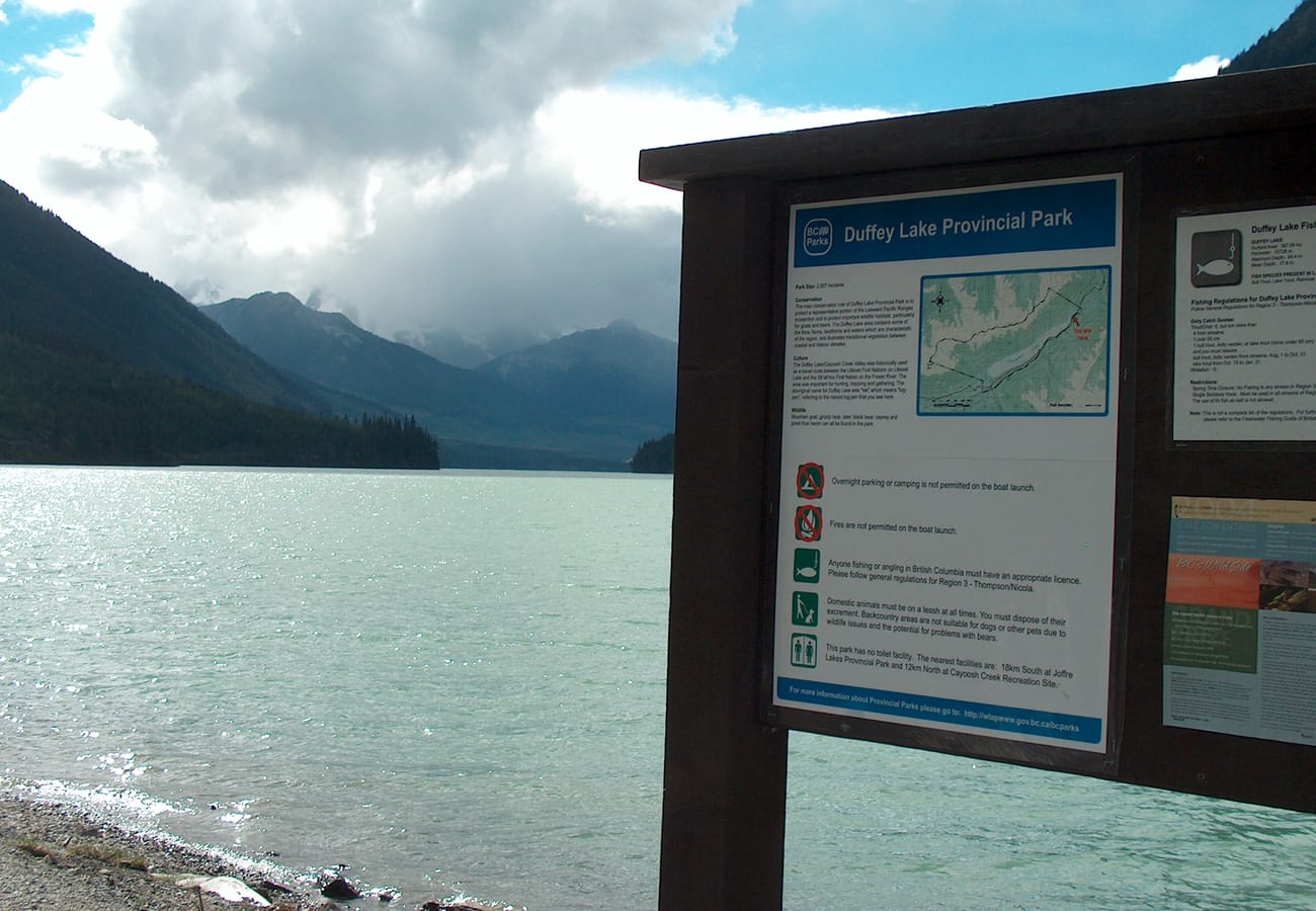 The serene turquoise waters of Duffey Lake reflecting alpine peaks along Highway 99