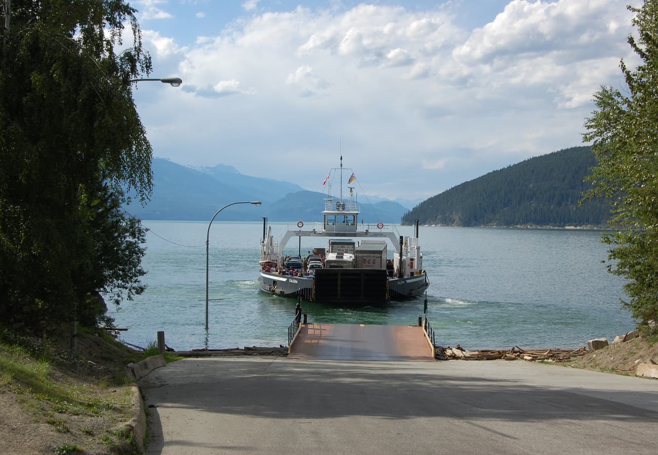 The scenic inland cable ferry gliding across Upper Arrow Lake beneath the forested Monashee Mountains