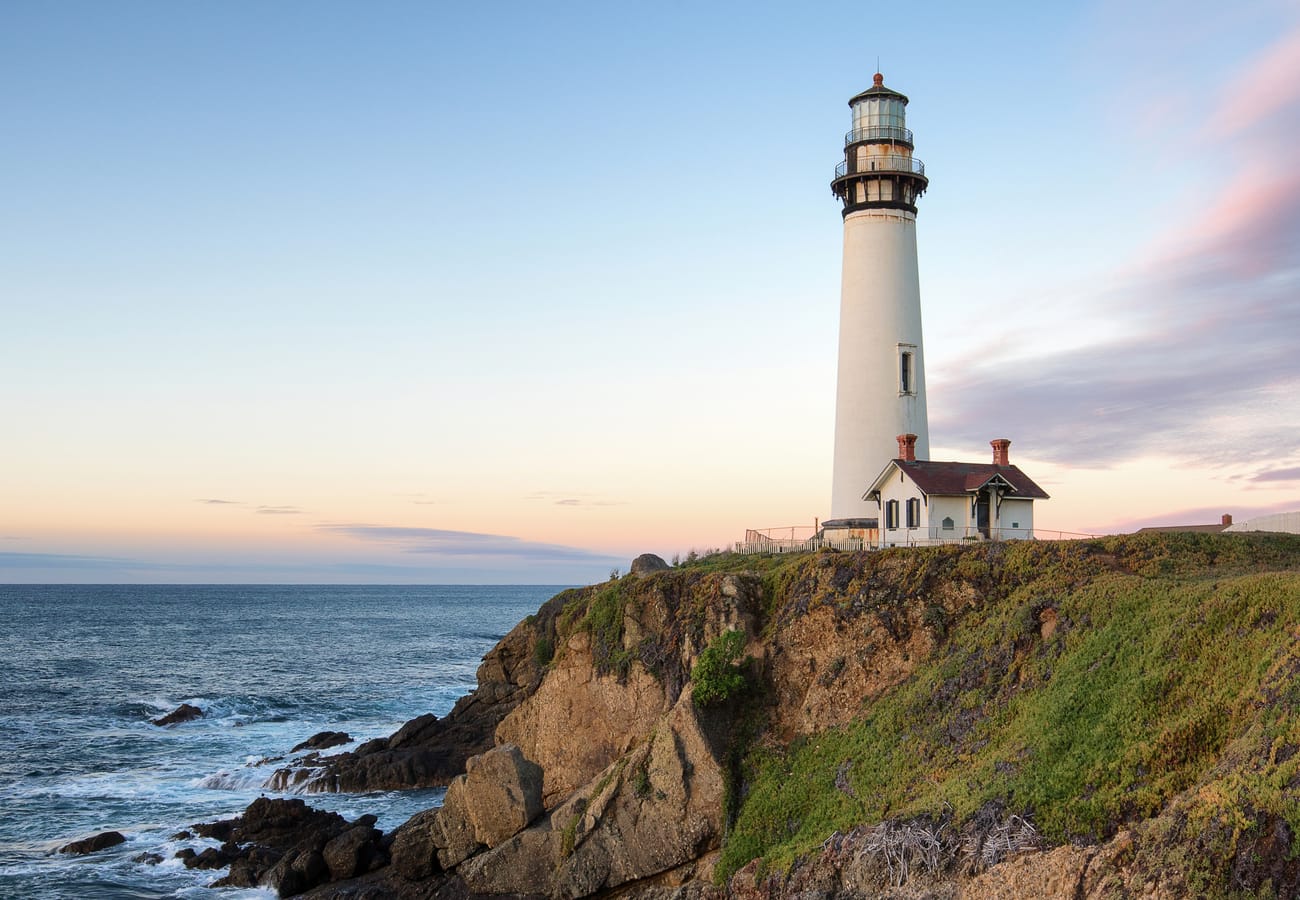 Pigeon Point Light Station standing over rocky ocean bluffs along Highway 1 in San Mateo County