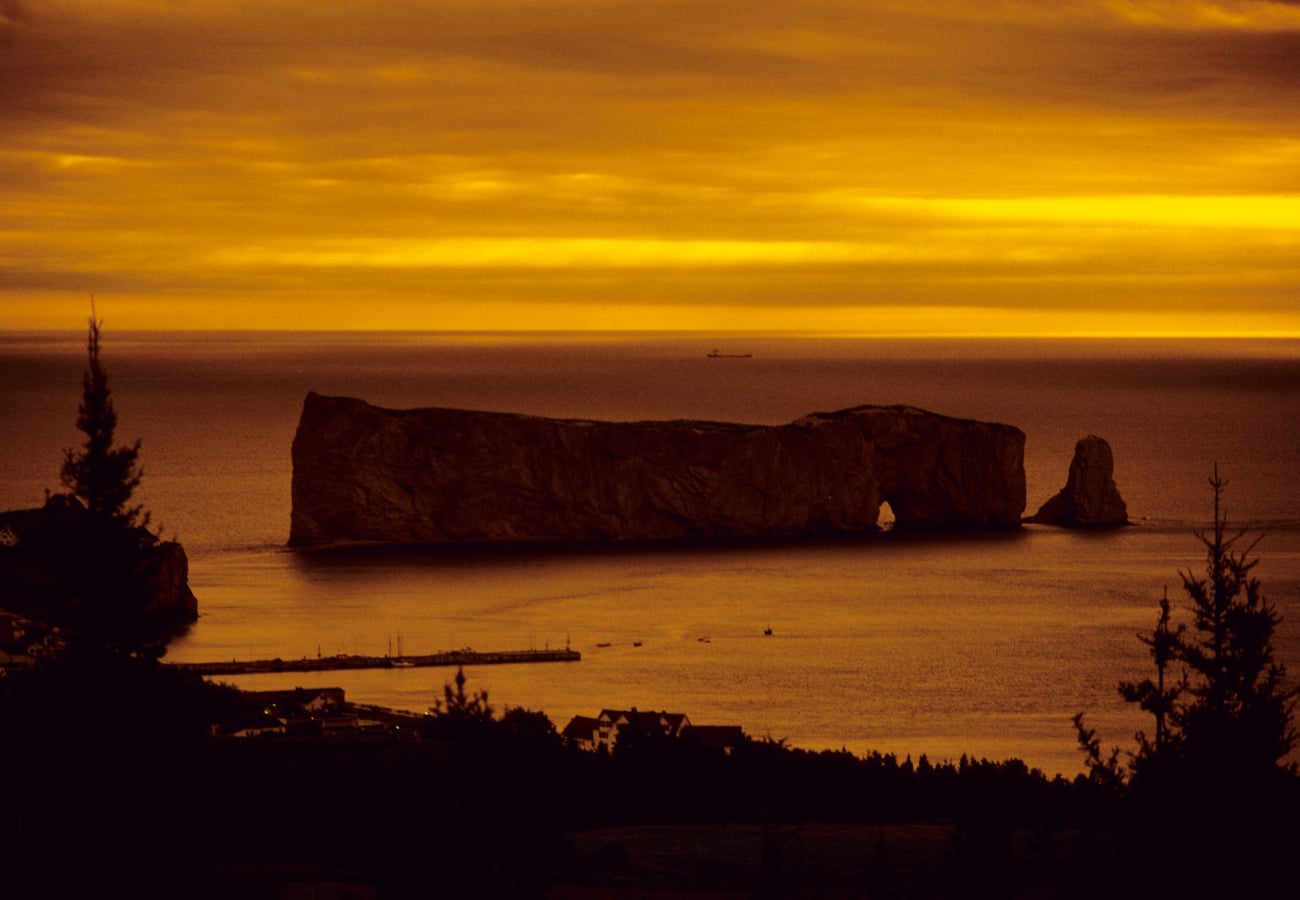 Colossal limestone arch of Perce Rock rising out of the Gulf of St Lawrence