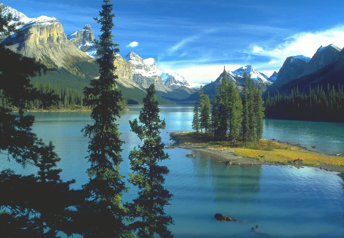 Spirit Island surrounded by glacial waters and peaks of Maligne Lake
