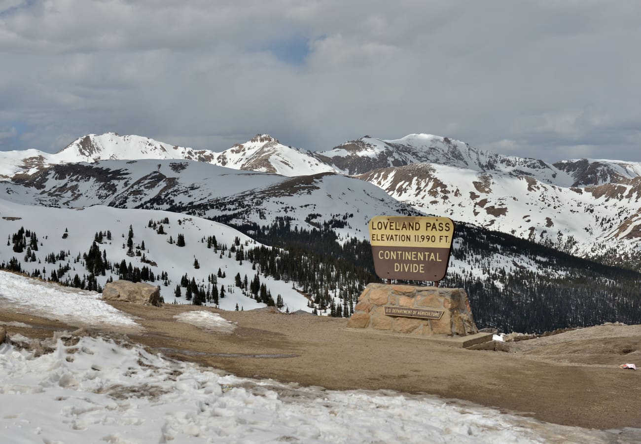 Continental Divide summit marker sign at 11,990-foot Loveland Pass in Colorado