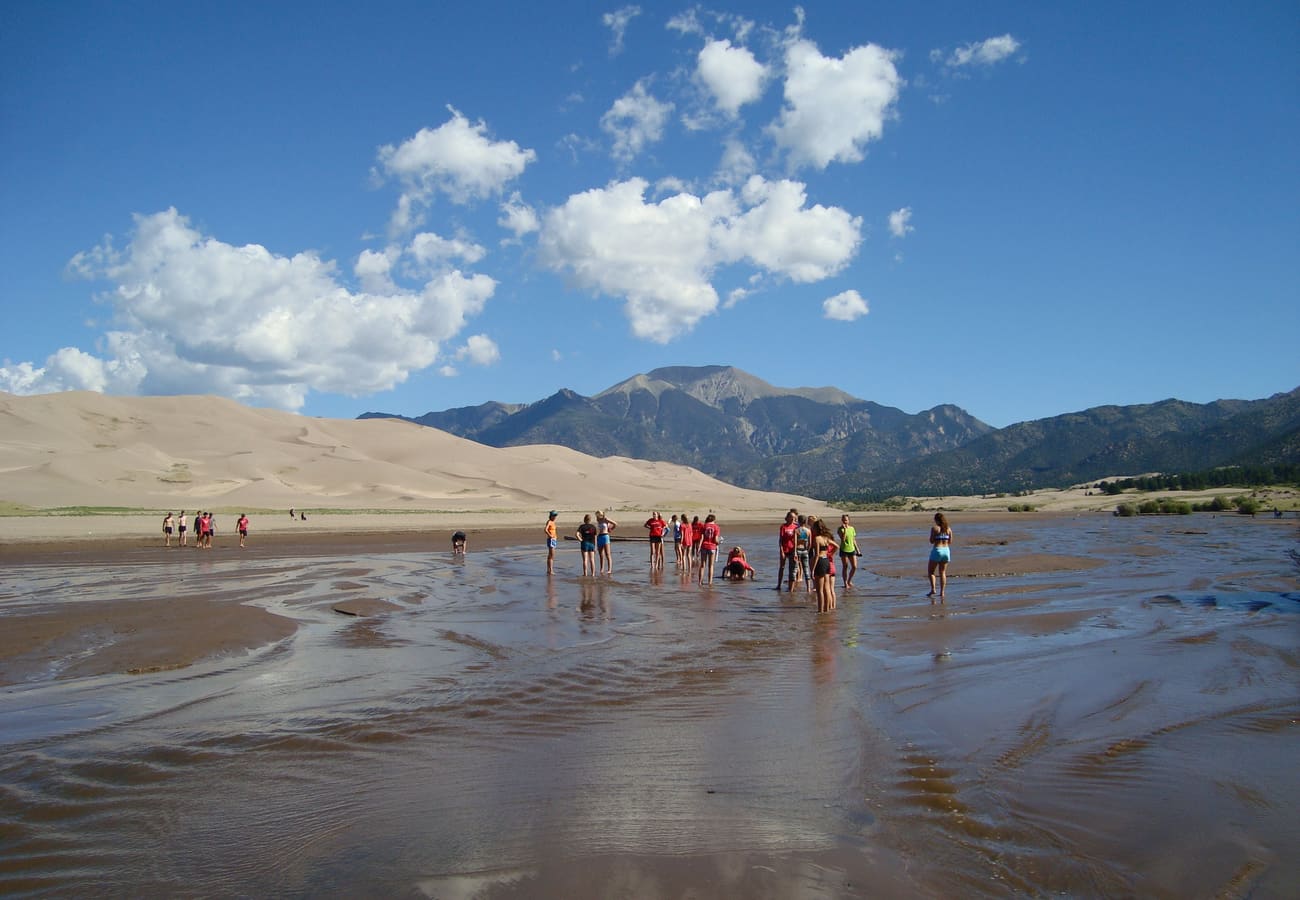 Massive sand dunes rising beneath the rugged peaks of the Sangre de Cristo Mountains in Colorado