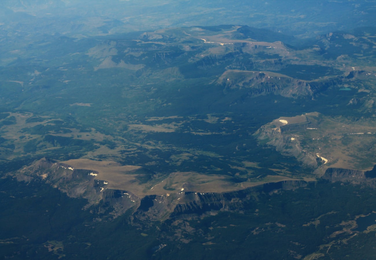 Broad flat-topped basalt cliffs and alpine forest along the Flat Tops Scenic Byway in Colorado