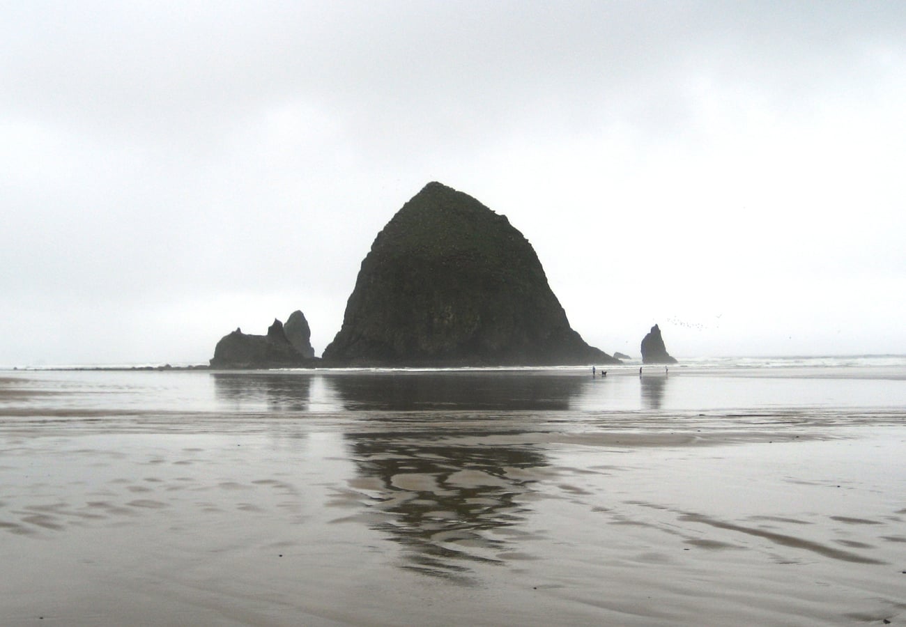Haystack Rock standing majestically against coastal surf at Cannon Beach Oregon