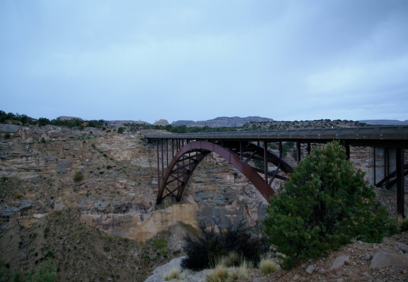 Steel arch highway bridge soaring over Eagle Canyon in the San Rafael Swell