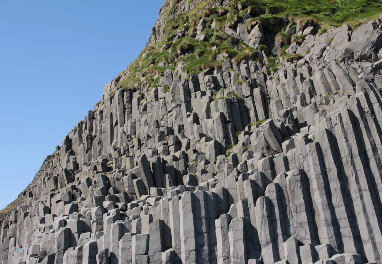 Towering hexagonal basalt columns and wild ocean surf at Reynisfjara
