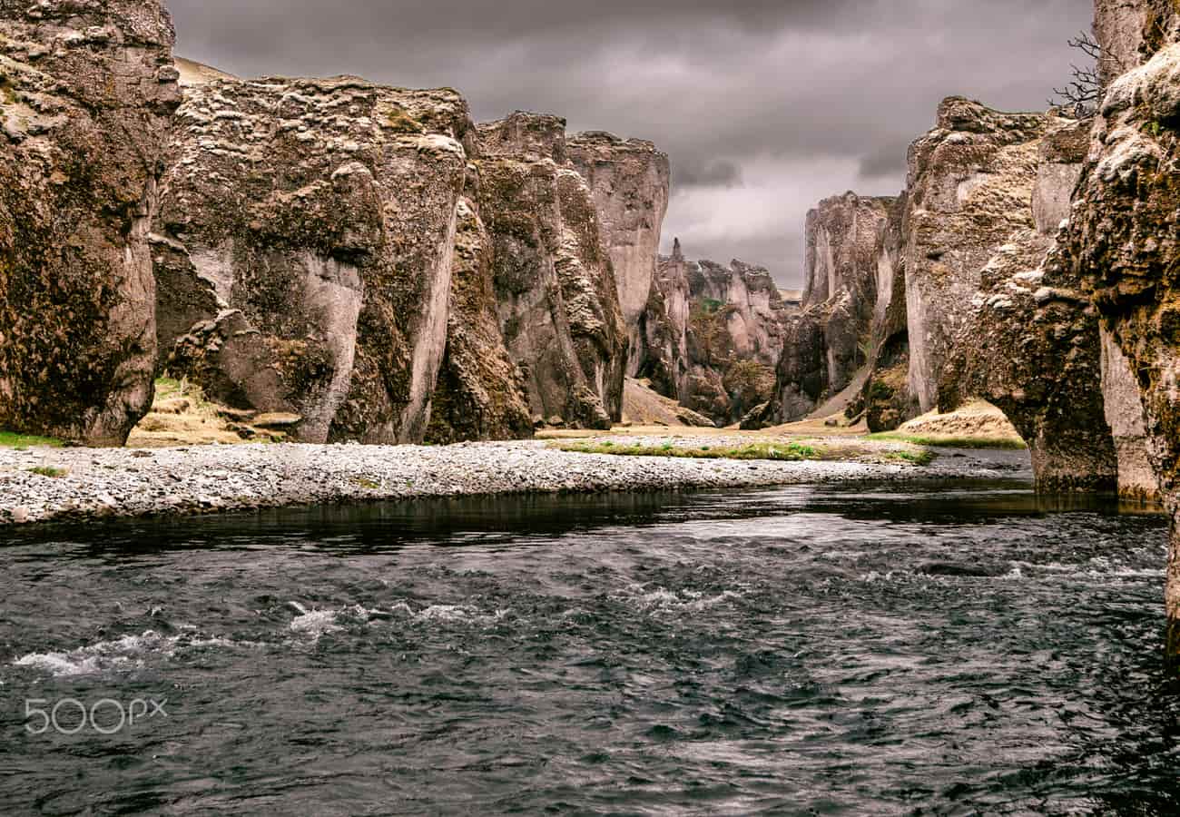 Dramatic serpentine twists and mossy vertical walls of Fjaðrárgljúfur Canyon