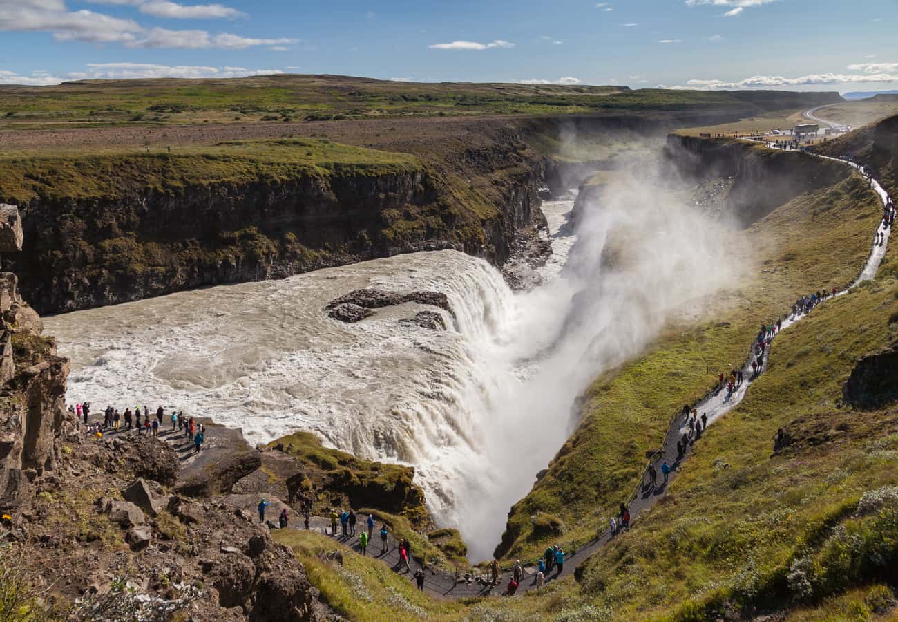 The powerful two-tiered cataract of Gullfoss waterfall plunging into a rugged canyon