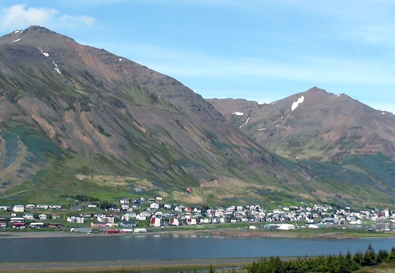 Panoramic views over the historic fjord town of Siglufjörður nestled under towering peaks