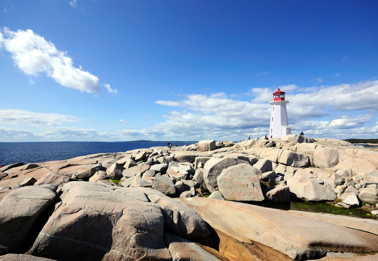 Peggy's Point Lighthouse perched atop polished coastal granite rocks