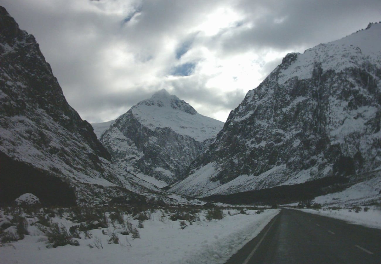 The Milford Road winding through the dramatic snow-dusted mountains of Fiordland