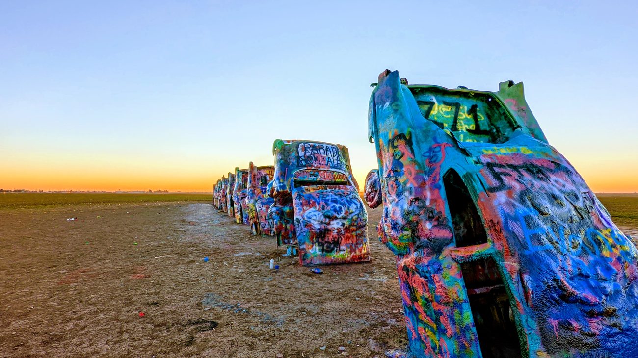 Cadillac Ranch cars buried nose-down in the Texas Panhandle during sunrise