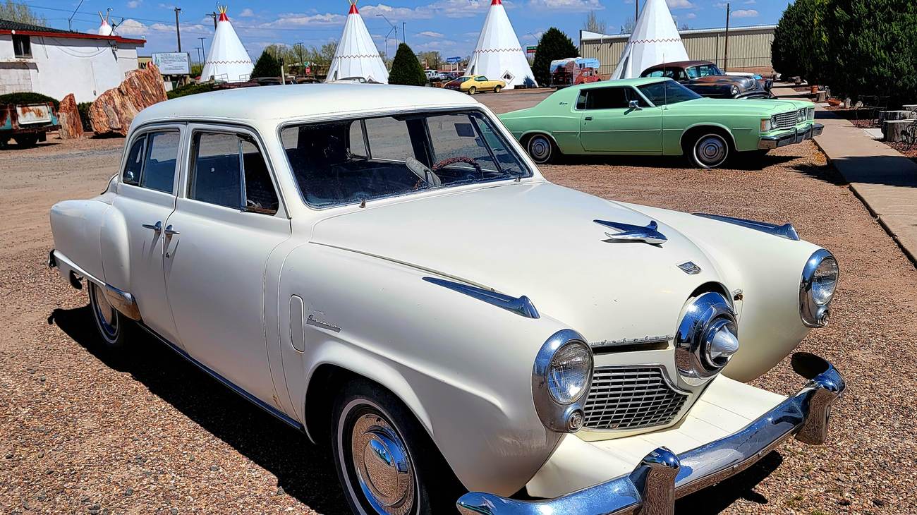 Vintage Studebaker parked outside the concrete teepees at the historic Wigwam Motel in Holbrook