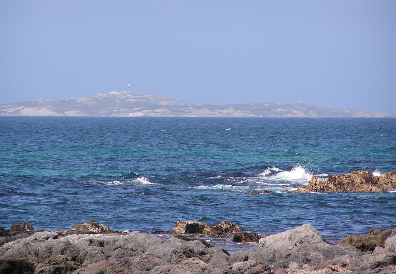 View of Montague Island offshore from the emerald coastline of Narooma