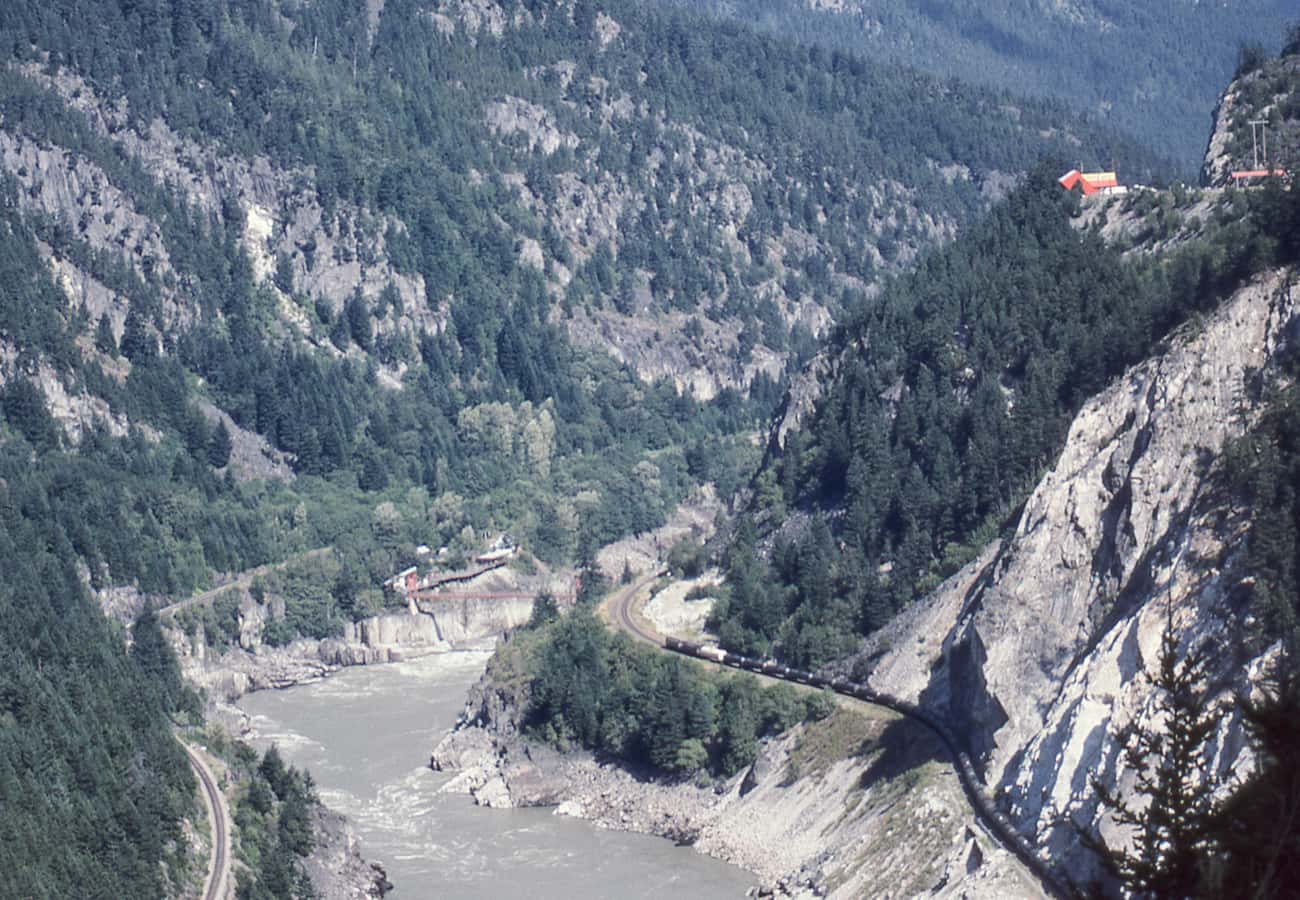 The Trans-Canada Highway winding through the steep rock cliffs and river narrows of Fraser Canyon