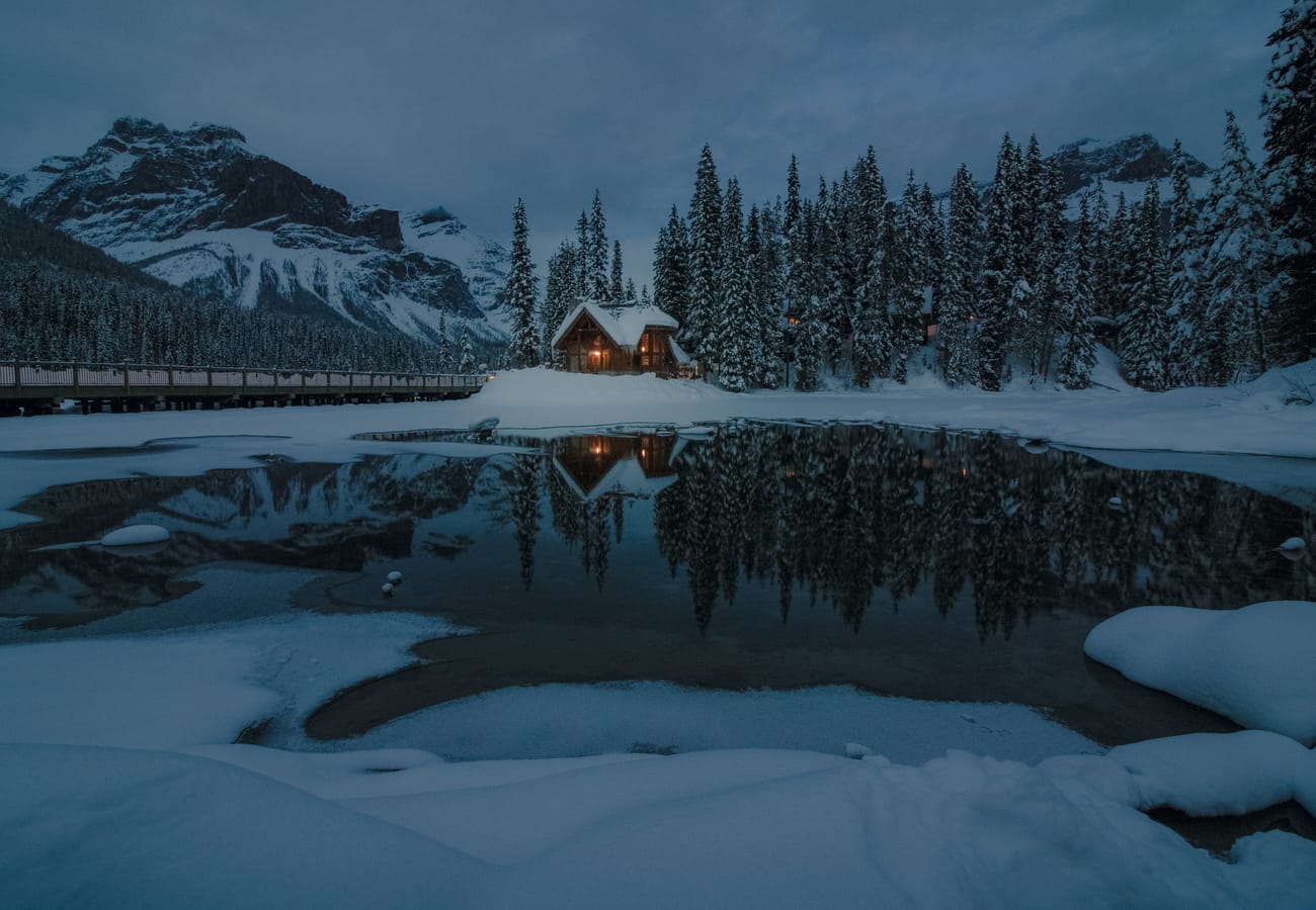 Emerald Lake brilliant turquoise water framed by the snow-covered peaks of Yoho National Park
