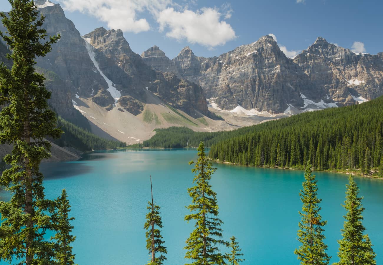 The world-famous turquoise glacial waters of Moraine Lake sheltered by the Valley of the Ten Peaks in Banff