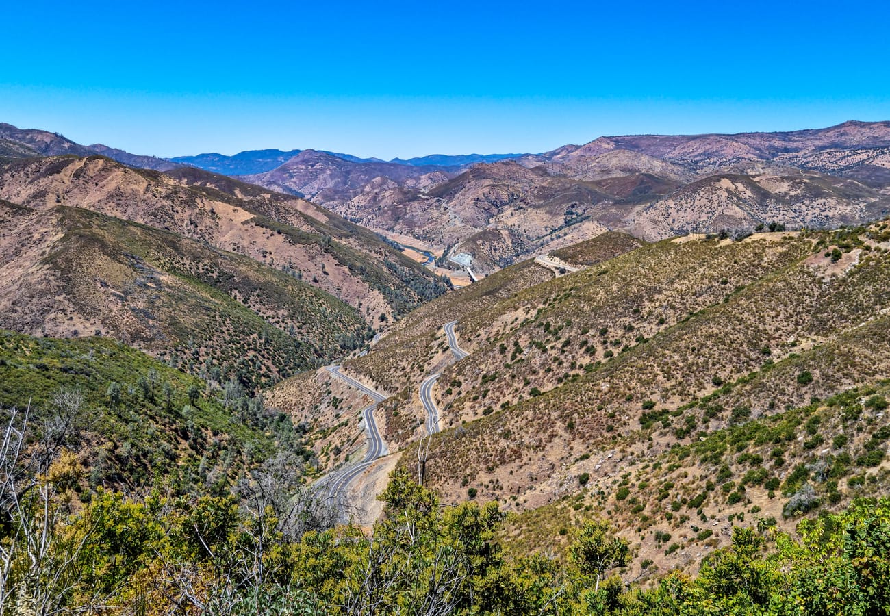 California Highway 49 winding through the rolling golden foothills of Bear Valley in Mariposa County