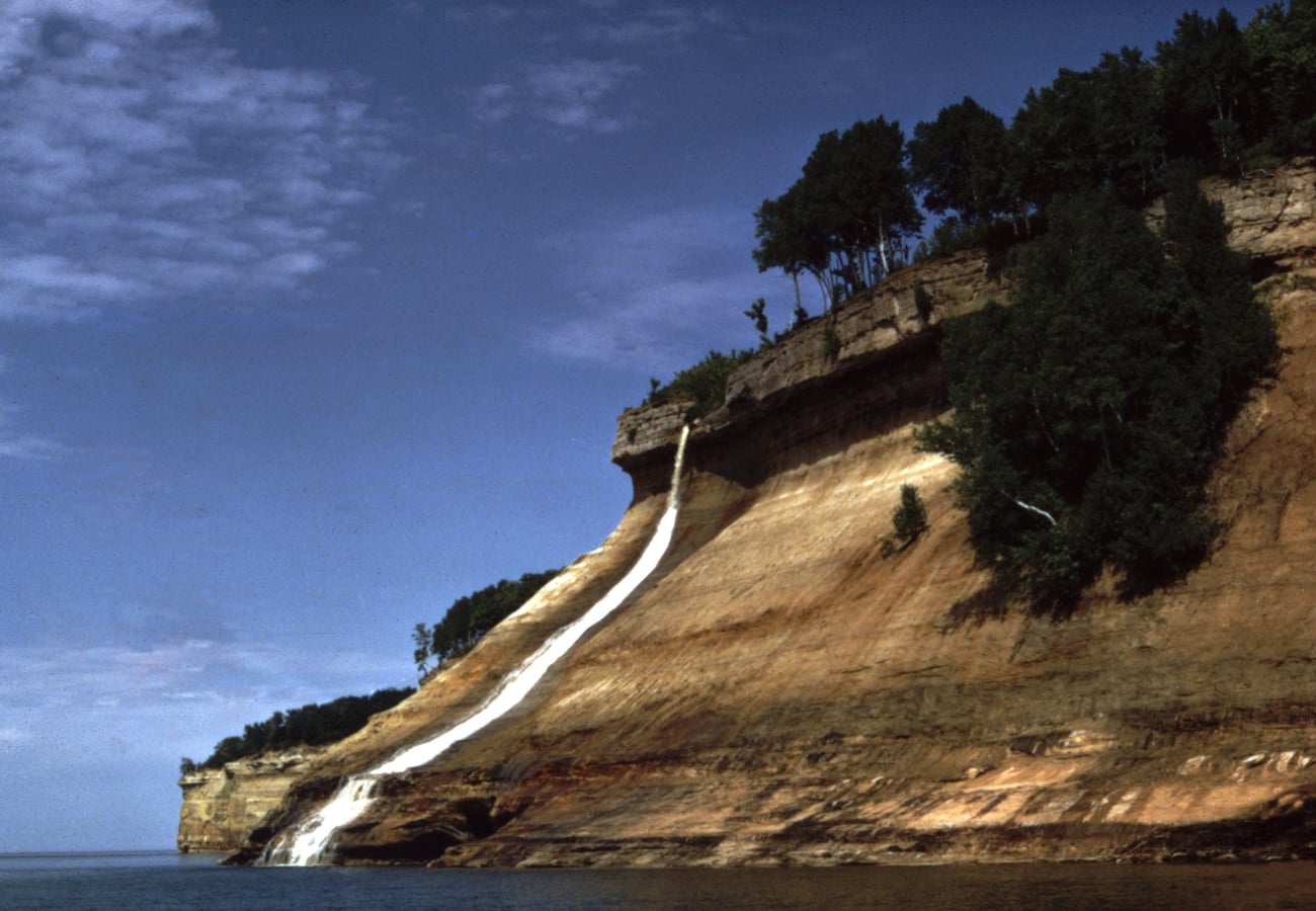 Dramatic sandstone cliffs and waterfalls at Pictured Rocks National Lakeshore